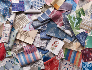 A colorful array of swatches of linens, wovens, wallpapers and grasscloths from Peter Dunham Textiles